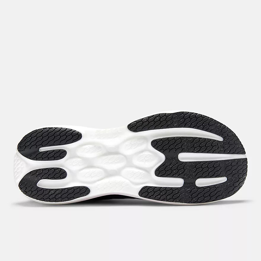 Close-up of a black and white New Balance Women's 1080 v15 athletic shoe sole on a white background